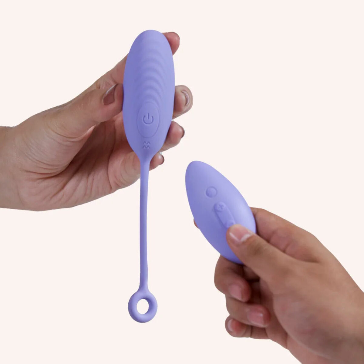 Dive egg massager held in hand, with its remote